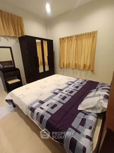 Cozy bedroom with modern decor and ample natural light, featuring a stylish bed and elegant curtains.