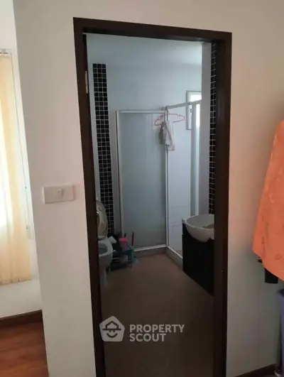Compact bathroom with shower and modern fixtures in cozy apartment