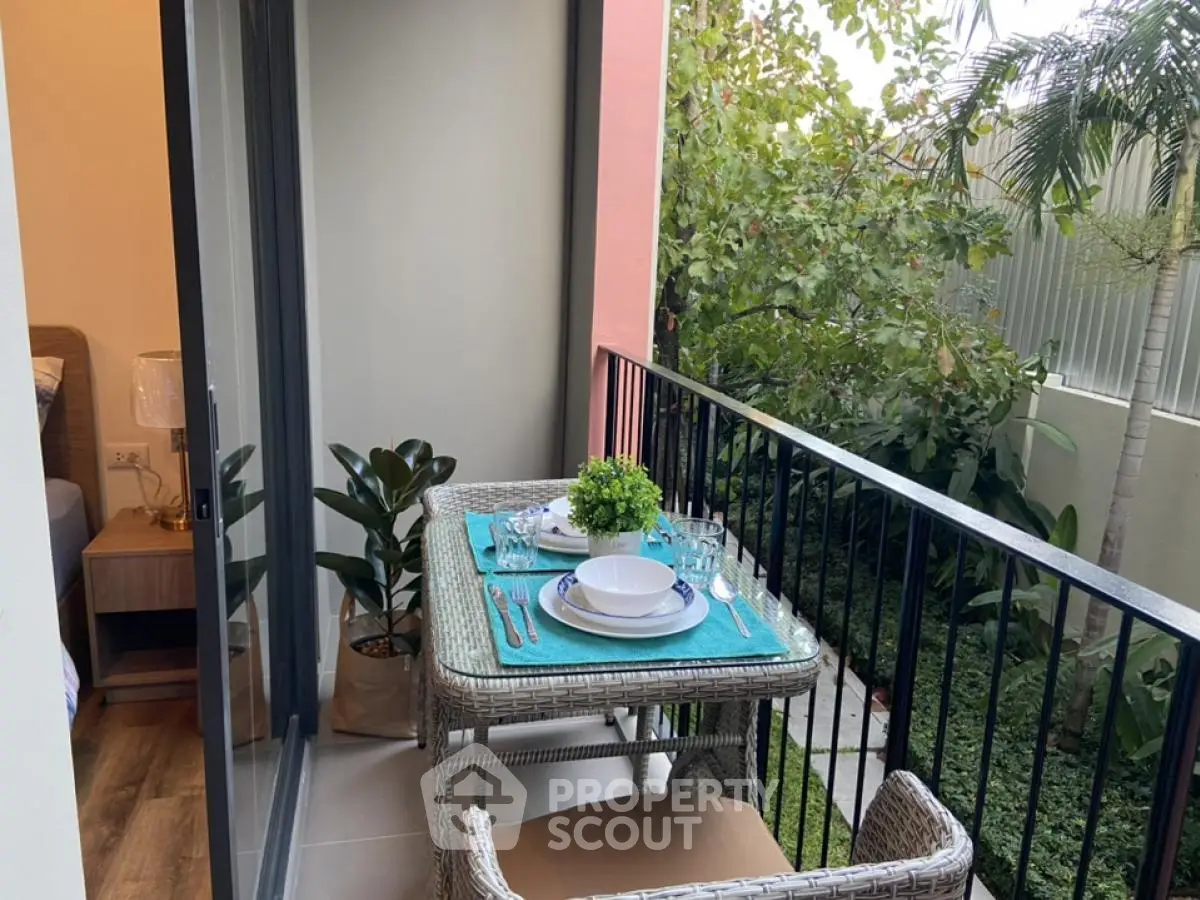 Charming balcony with outdoor dining set and lush garden view