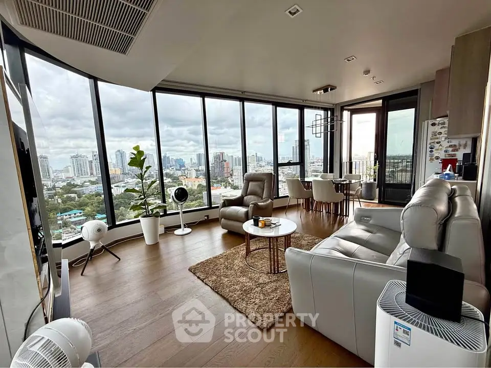 Luxurious corner unit living room with panoramic city views and modern furnishings.