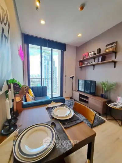 Modern living room with dining area and city view from balcony in high-rise apartment.