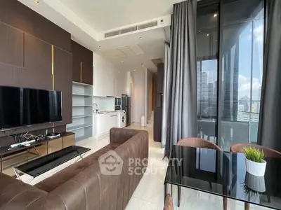 Modern living room with open kitchen, sleek furniture, and large windows offering city views.