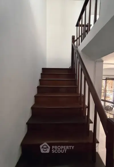 Elegant wooden staircase with sleek railing in modern home interior