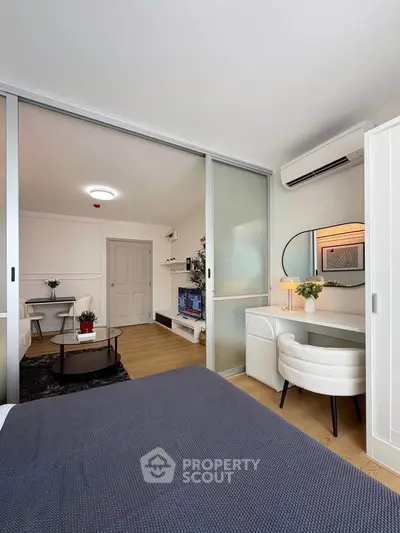 Modern living room with sliding glass doors, stylish decor, and cozy seating area.