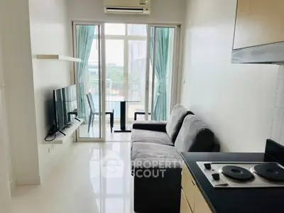Modern living room with balcony view and sleek kitchen area