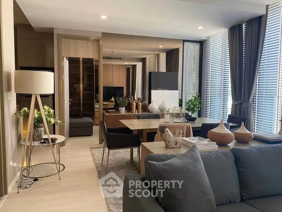 Modern living room with stylish decor and large windows in a luxury apartment.