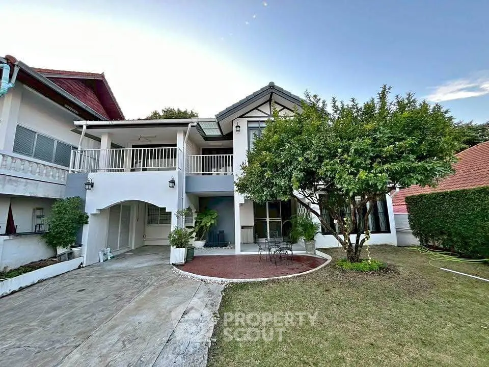 Charming two-story house with spacious garden and elegant balcony