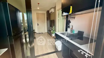 Modern kitchen with sleek black cabinetry and open layout in stylish apartment