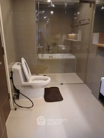 Modern bathroom with glass shower and sleek fixtures in a contemporary apartment.