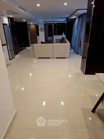 Spacious modern living room with glossy tiled floors and elegant decor