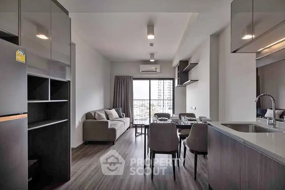 Modern open-plan living room with dining area and city view balcony.