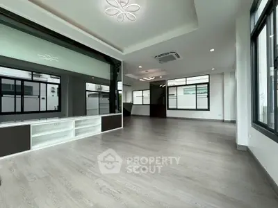 Spacious modern living room with large windows and sleek flooring