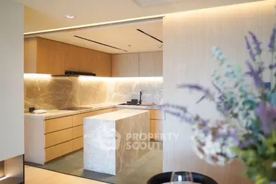 Modern kitchen with sleek marble island and warm wooden cabinetry