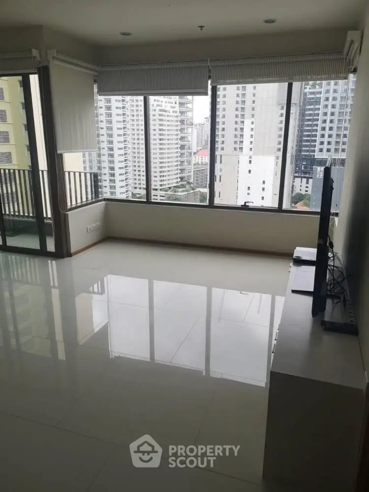 Spacious modern living room with large windows and city view
