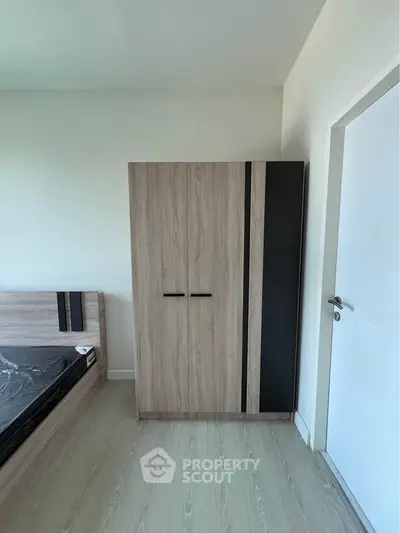 Modern bedroom with sleek wardrobe and bed in minimalist design