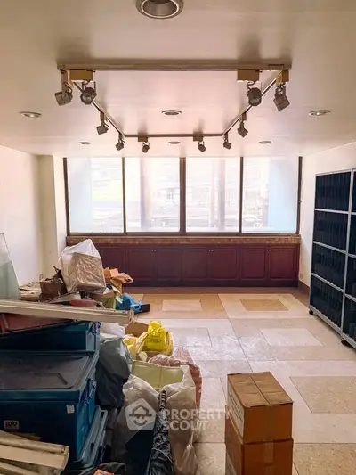 Spacious storage room with large windows and ample shelving space.