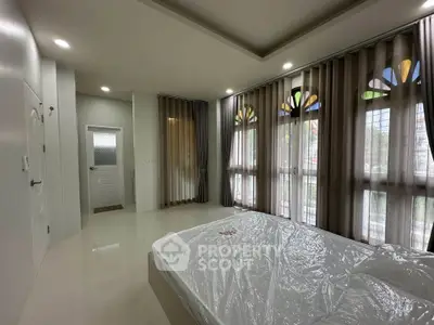 Spacious bedroom with large windows and modern design