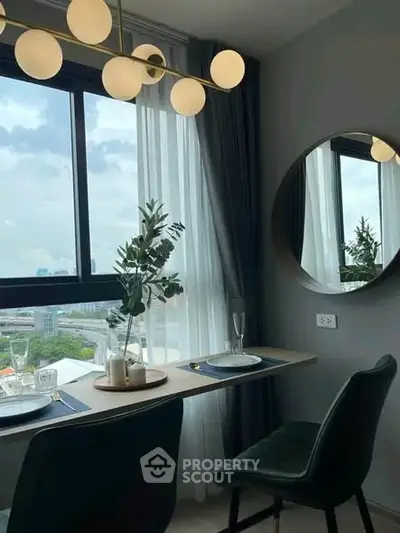 Stylish dining area with city view, modern decor, and elegant lighting in a high-rise apartment.