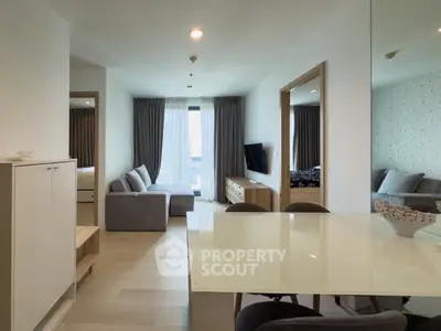 Modern living room with stylish furniture and large window offering city view