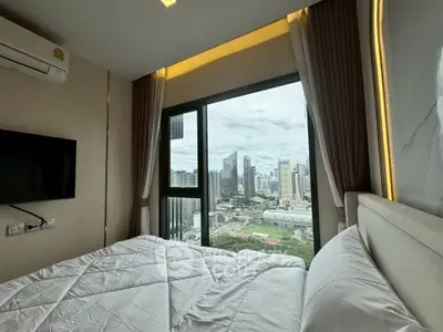 Luxurious bedroom with stunning city view from high-rise apartment