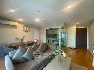 Modern living room with cozy sofa and open kitchen layout