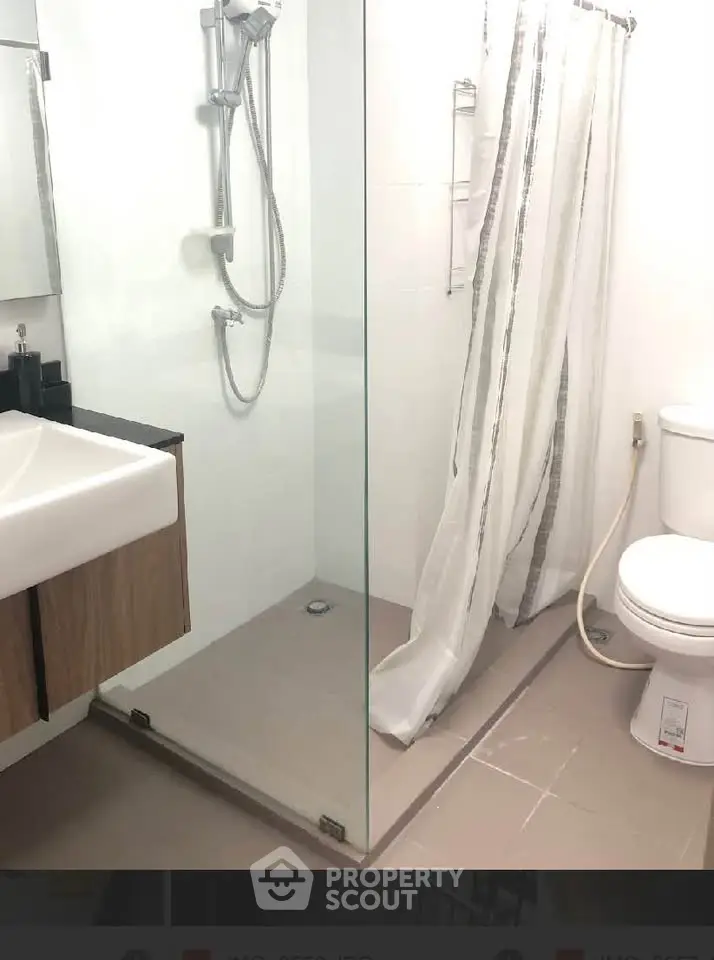 Modern bathroom with glass shower and sleek fixtures in a contemporary apartment.