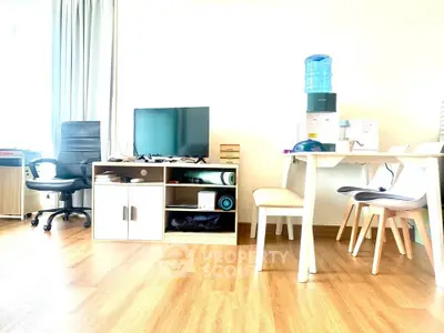 Bright and modern living room with wooden flooring, TV unit, and dining area, perfect for cozy gatherings.