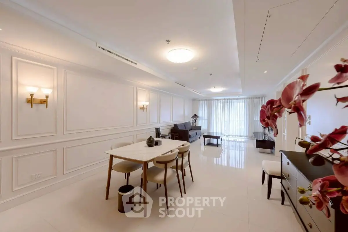 Elegant open-plan living and dining area with modern decor and natural light