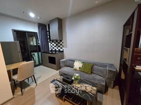 Modern living room with stylish decor and open kitchen layout in a cozy apartment.