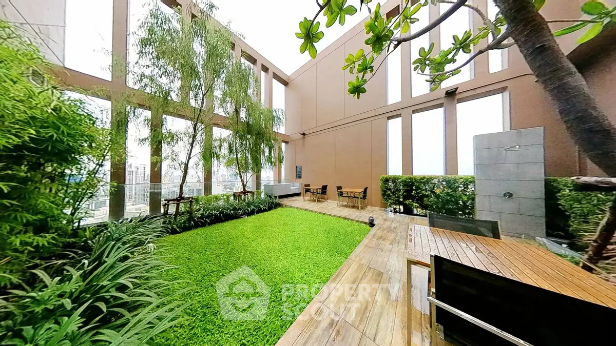 Luxurious rooftop garden with lush greenery and modern seating area in urban setting.