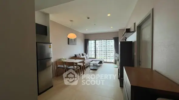 Spacious modern living room with dining area and large windows in a stylish apartment.