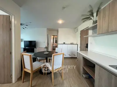 Modern open-plan living room with dining area and stylish wooden furniture.