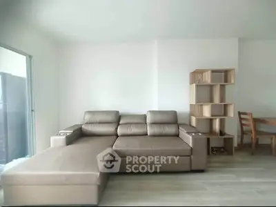 Spacious living room with modern leather sofa and stylish wooden furniture