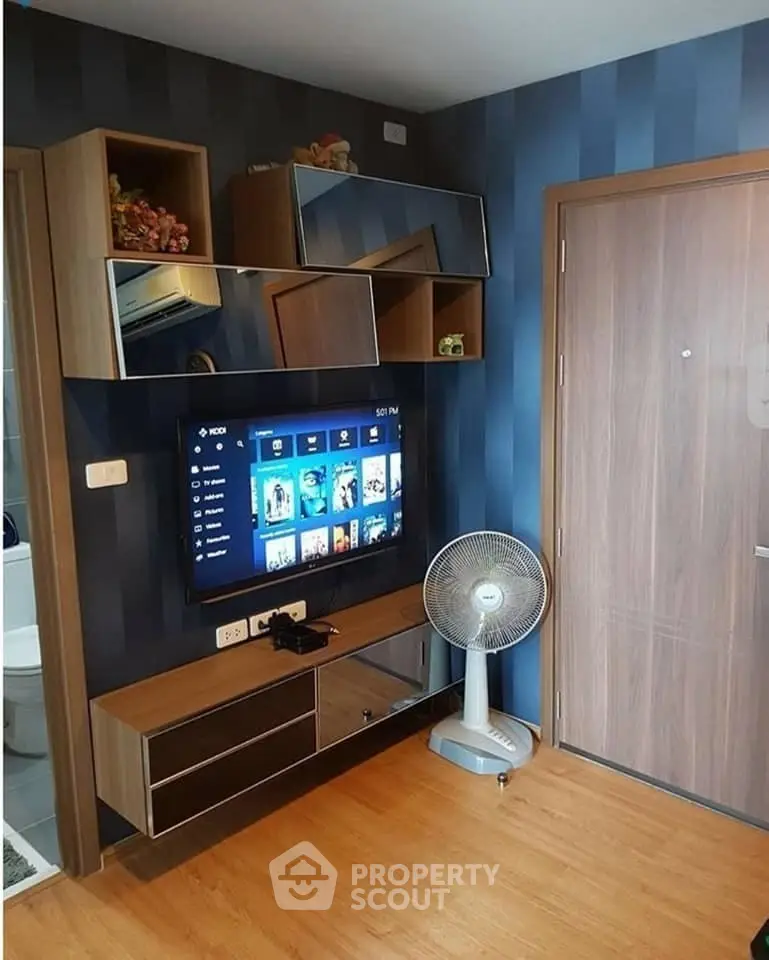 Modern living room with wall-mounted TV and stylish storage units
