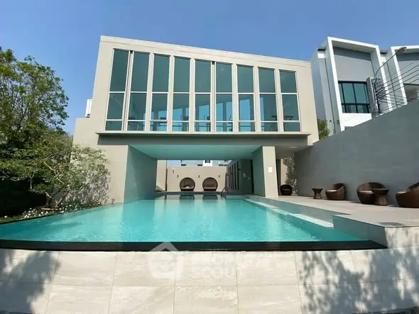 Luxurious modern home with stunning pool and sleek architectural design.