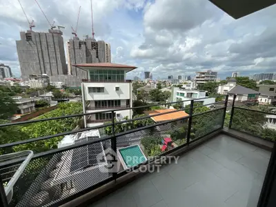 Spacious balcony with cityscape view and modern architecture