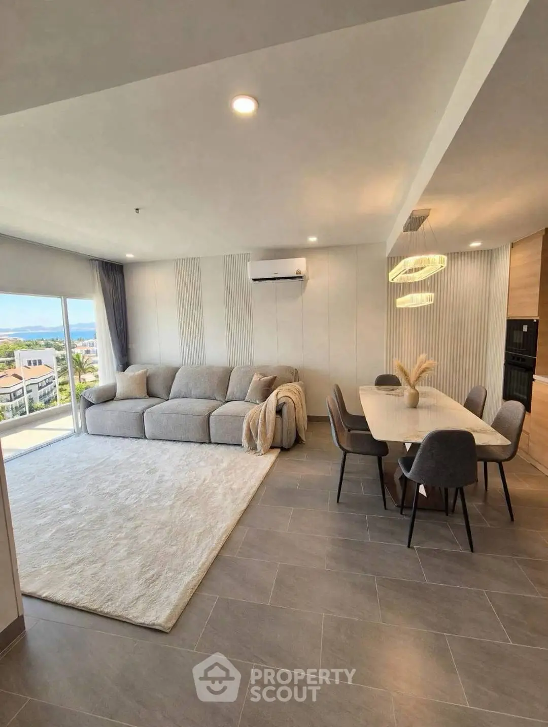 Spacious modern living room with dining area and scenic view