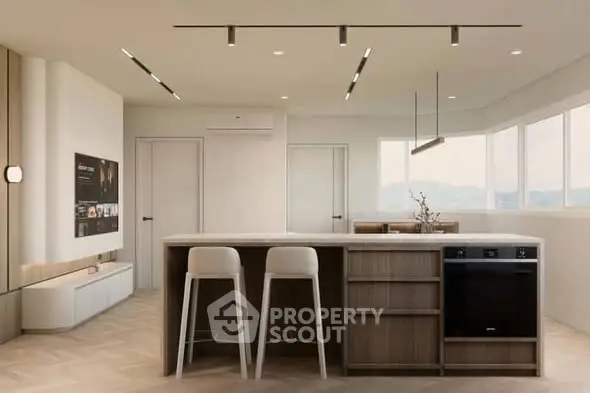 Modern kitchen with sleek design, featuring an island, bar stools, and built-in appliances in a bright open space.