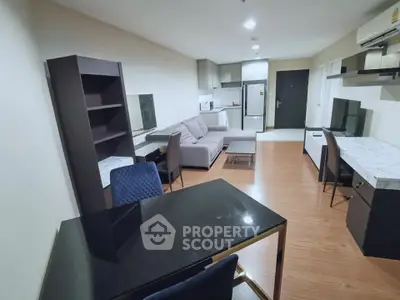 Modern living room with stylish furniture and open kitchen layout in a cozy apartment.