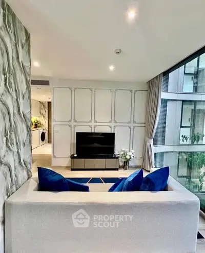 Modern living room with elegant decor and large windows offering a stunning view.