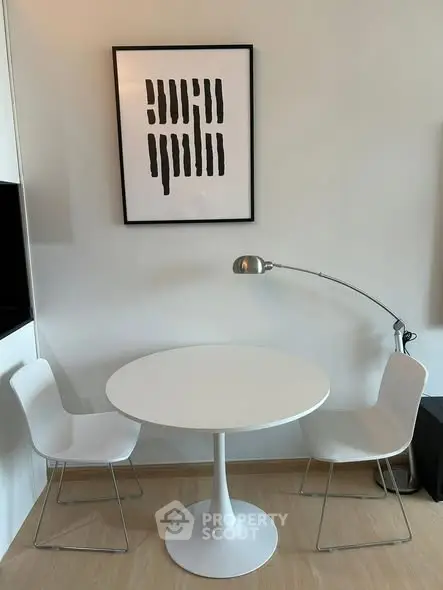 Modern minimalist dining area with round table and stylish chairs