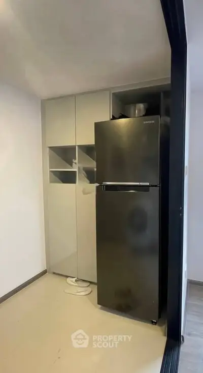 Modern kitchen with sleek refrigerator and minimalist cabinetry