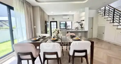 Spacious modern dining area with elegant decor and open kitchen layout in a bright home.