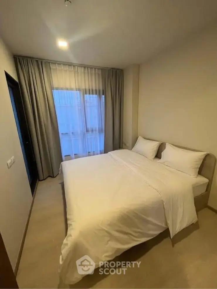 Cozy bedroom with large bed and soft lighting, perfect for relaxation and comfort.