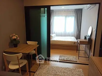 Cozy modern bedroom with sliding glass door and stylish furniture in a well-lit apartment.