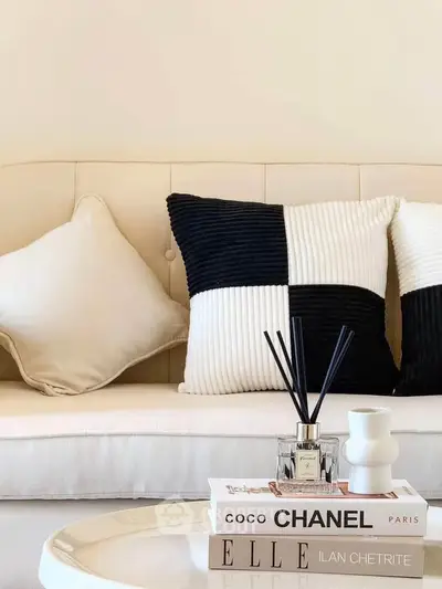 Stylish modern living room with elegant decor and designer books on a chic coffee table.