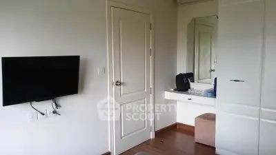 Modern bedroom with wall-mounted TV and sleek wardrobe design