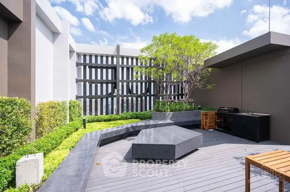 Modern rooftop terrace with stylish seating and lush greenery, perfect for outdoor relaxation and entertainment.