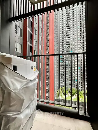 Modern balcony with city view and washing machine in high-rise apartment
