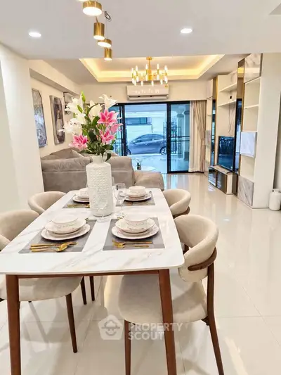 Elegant dining area with modern decor and large windows in a luxurious apartment.